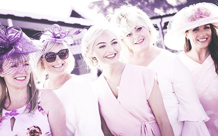 Group of dressed up ladies posing for a photo at Uttoxeter Racecourse.