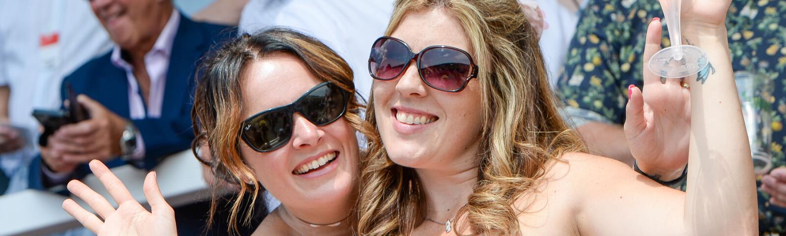 Two race goers pose for a picture in the stands at Uttoxeter Races