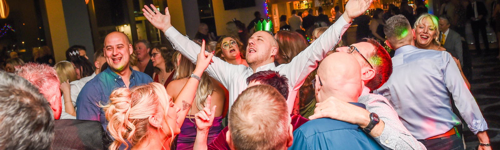 People smiling, laughing and dancing at Uttoxeter's Christmas Party Nights.