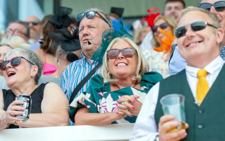 A group of racegoers enjoy the races at Uttoxeter from the grandstand