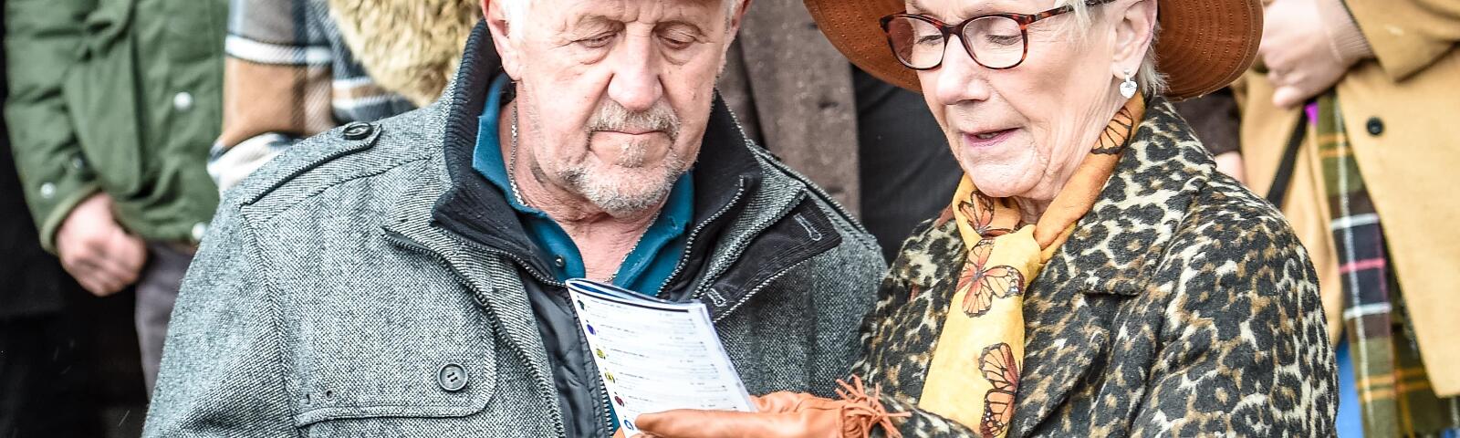 A couple in the grandstand at Uttoxeter Races view the race card