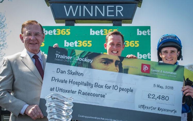 Jockey, trainer and an owner holding a award in their hands.