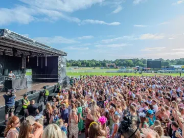 The crowd dancing to a live DJ set in the sunshine at Uttoxeter Races