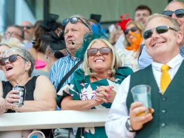 A group of racegoers enjoy the races at Uttoxeter from the grandstand