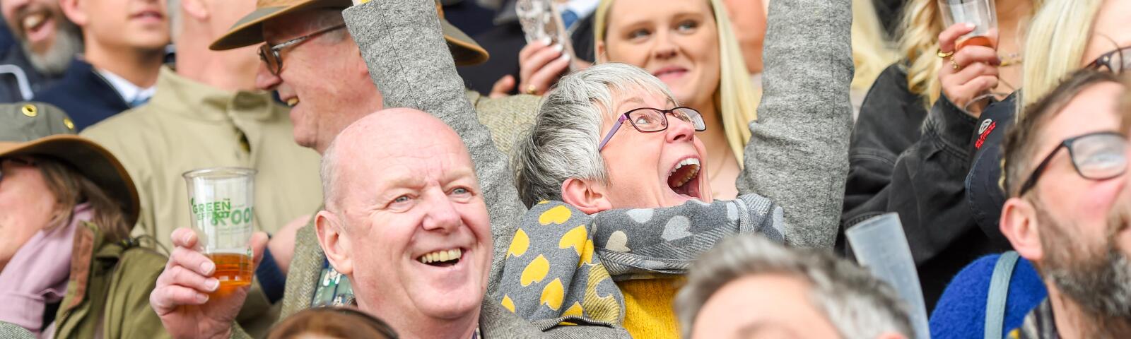 A race goer enthusiastically cheers in the crowd at Uttoxeter Races