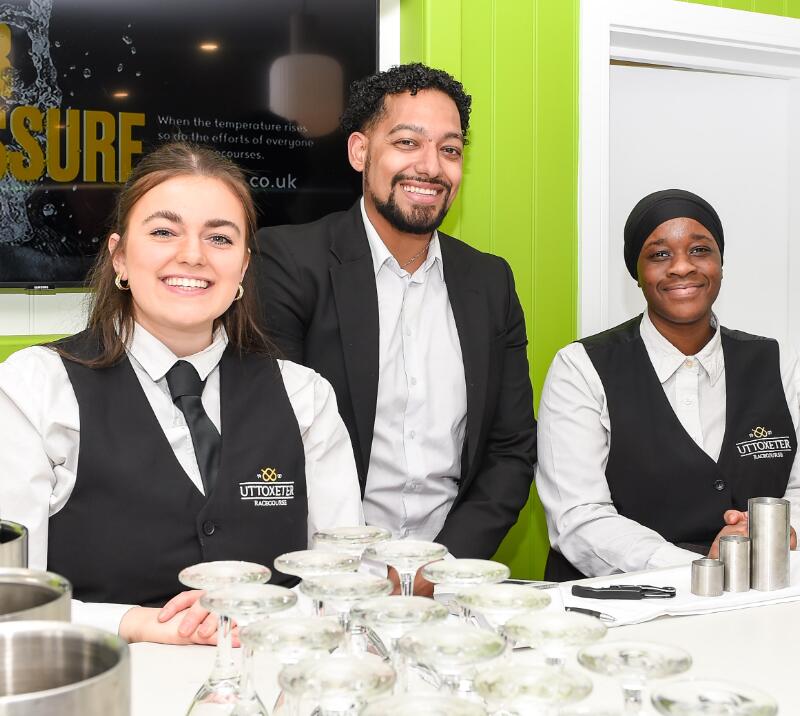 Waiting staff at Uttoxeter Racecourse smile for the camera