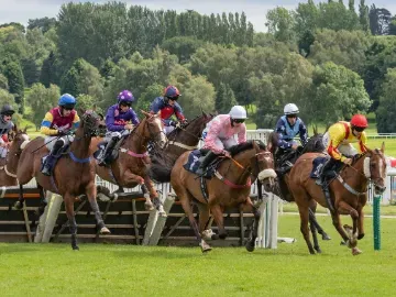 Horses taking on a jump at Uttoxeter Races