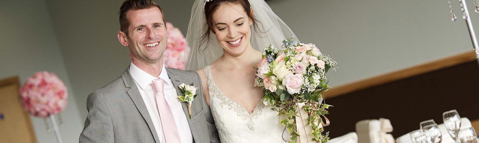 Bride and Groom smile at their wedding reception