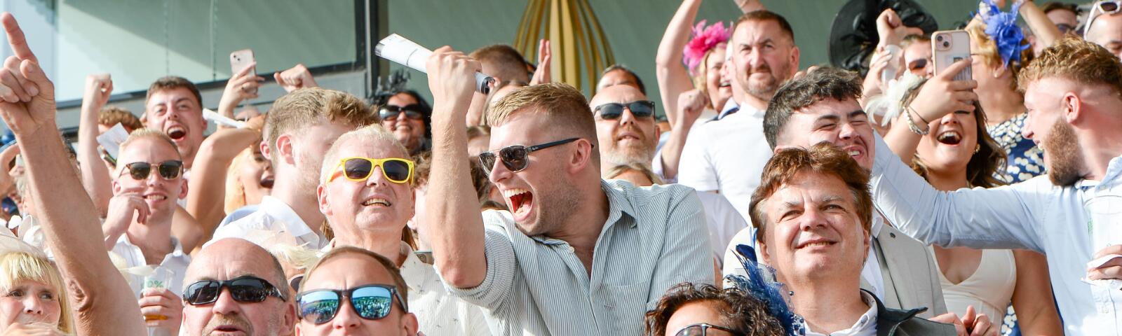 Some of the Uttoxeter Races crowd cheering the end of a race