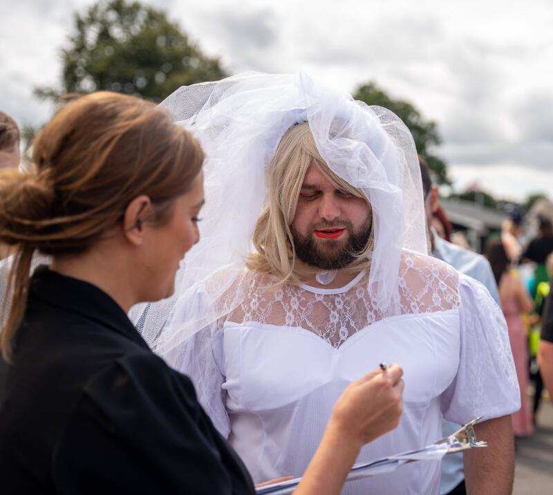 A groom to be wearing a veil and celebrating his stag do at Uttoxeter Races