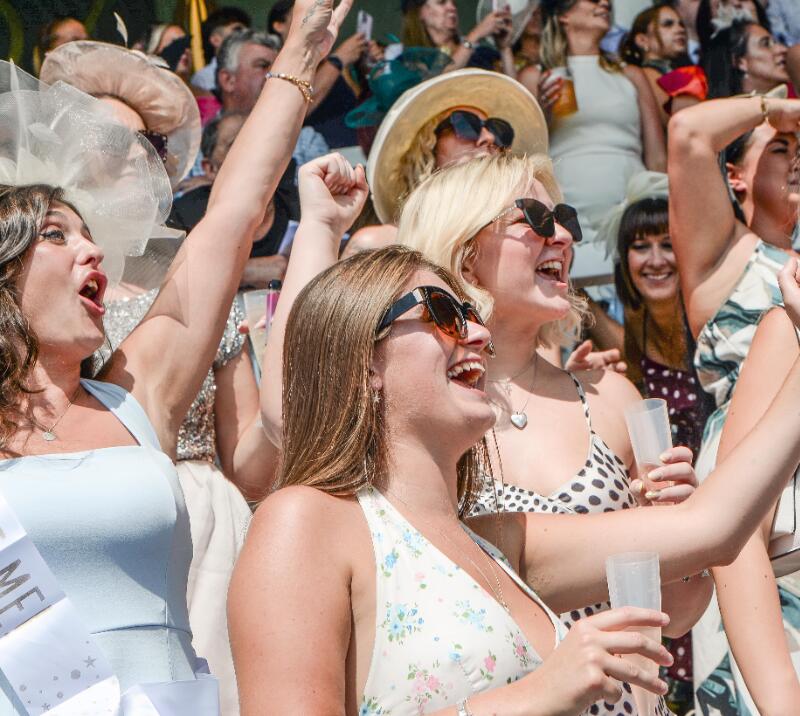 A group of ladies at Uttoxeter Races cheer excitedly
