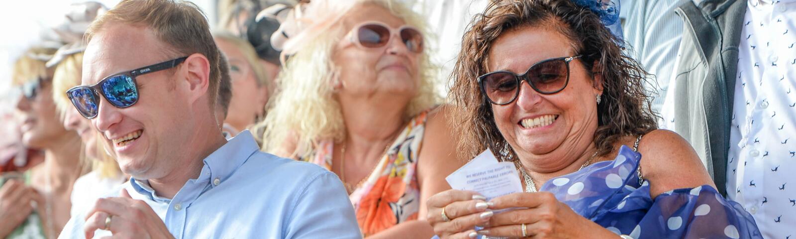 A Uttoxeter race goer smiles at her betting slip